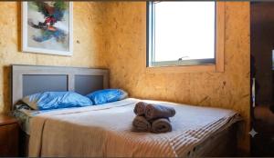 a bedroom with a bed with towels on it at Tsovazard Holiday House in Tsovazard