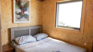 a small bedroom with a bed and a window at Tsovazard Holiday House in Tsovazard +10 photos