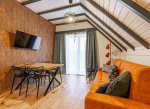 a living room with a couch and a table at Bieszczadzka Panorama in Ustrzyki Dolne