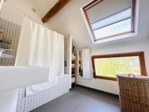 a bathroom with a tub and a sink and a window at La Masure in Les Rameaux +15 photos