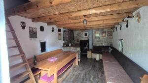 a room with a wooden bench and a fireplace at Pridvorica in Gacko