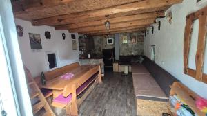a room with a table and benches in a building at Pridvorica in Gacko