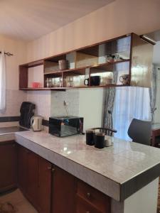 a kitchen with a counter top with a microwave at Lantana Luxe in Nairobi