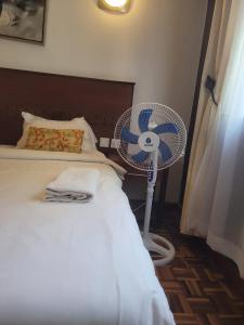 a bedroom with a white fan next to a bed at Lantana Luxe in Nairobi +16 photos