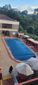 an empty swimming pool with umbrellas in front of a building at Lantana Luxe in Nairobi