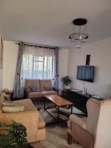 a living room with a couch and a piano at Lantana Luxe in Nairobi