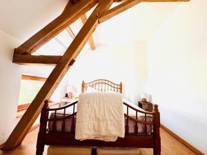 a bedroom with a bed in a attic at La Masure in Les Rameaux