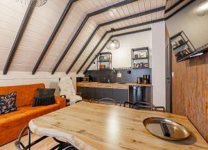 a living room with a wooden table and a couch at Bieszczadzka Panorama in Ustrzyki Dolne