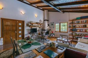a living room with a table and chairs and bookshelves at Villa Robinson in Petrovac na Moru