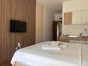 a bedroom with a bed with towels on it at Guesthouse P&A in Budva
