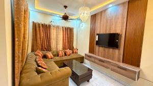 a living room with a couch and a flat screen tv at Complete Comfy House with 3 beds Al-Hafeez Garden Lahore in Lahore
