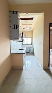 a large empty room with a counter in a kitchen at Complete Comfy House with 3 beds Al-Hafeez Garden Lahore in Lahore