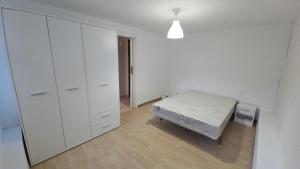 a bedroom with a bed and a large white cabinet at WHITE TREE Azalea in Ferrol