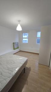 a large white room with a bed in it at WHITE TREE Azalea in Ferrol