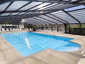 a large swimming pool with chairs at Camping La Verte Prairie in Forest-Montiers