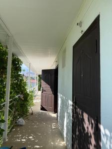 a hallway with two doors on the side of a building at Aiperii in Bosteri