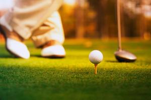 a golfer is standing next to a golf ball at Toten Hotel Sillongen in Eklund