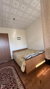 a bedroom with a large bed and a coffered ceiling at Aiperii in Bosteri