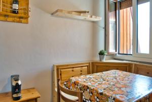 a dining room with a table and a window at Casa Rachele - mountain panorama in Cassina Valsassina