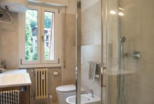 a bathroom with a shower and a toilet and a sink at Casa Rachele - mountain panorama in Cassina Valsassina +21 photos