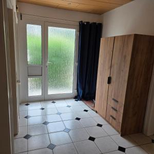 a room with a door and a tiled floor at Ferienhaus Schwerte Ergste im Ruhrtal in Schwerte