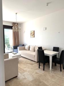a living room with a couch and a table at Sea View Residence with Pool & Private Terrace in Krstac