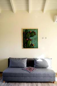 a couch in a room with a painting on the wall at Olive Coast Houses in Kyparissia