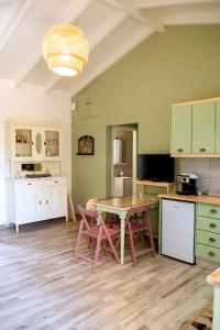 a kitchen with a table and chairs in a room at Olive Coast Houses in Kyparissia