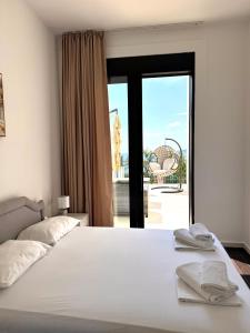 a bedroom with a bed with a view of a patio at Sea View Residence with Pool & Private Terrace in Krstac +21 photos