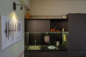 a kitchen with a sink and a counter top at FLH Residences, Ambawadi in Ahmedabad +82 photos