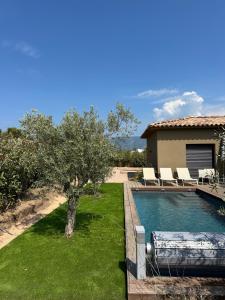 a backyard with a swimming pool and a house at Villas Vangarone in Lecci