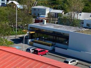 a red truck parked in front of a blue building at City Hall Apartments in Borgarnes