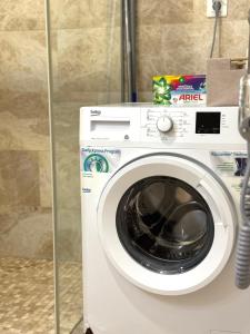 a white washing machine sitting in a bathroom at Sea View Residence with Pool & Private Terrace in Krstac