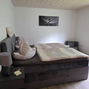 a bed sitting in a room with a wall at Ferienhaus Schwerte Ergste im Ruhrtal in Schwerte