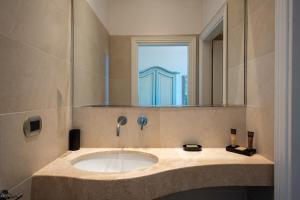 a bathroom with a sink and a mirror at La Villa in Siena +41 photos