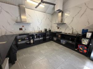 a kitchen with black counters and marble walls at Darwin city Studio in Darwin