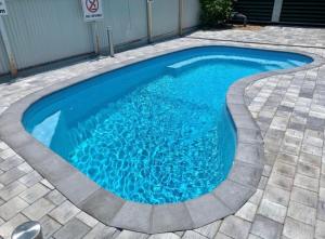 a swimming pool with blue water in a patio at Darwin city Studio in Darwin