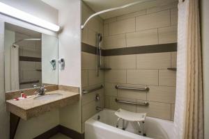 a bathroom with a sink and a tub and a toilet at Super 8 by Wyndham Flagstaff in Flagstaff +31 photos
