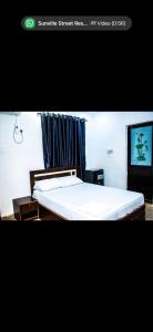 a bedroom with a bed and a tv in it at Mo Exortic Royale Services in Ikorodu