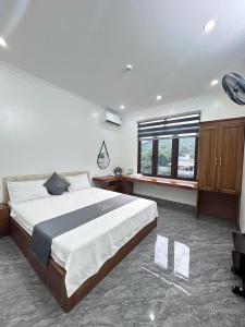 a bedroom with a large bed and a window at Cloudy Hotel in Ha Giang