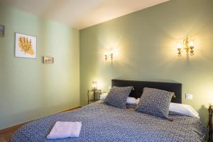 a bedroom with a bed with two pillows on it at Gîte l' Odyssée in Espalion