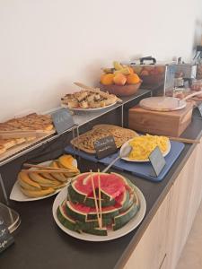 a buffet filled with lots of different types of food at Hotel Fazio in Bonifacio