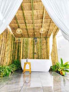 a bathroom with a bath tub in a straw roof at X2 privacy villa in Khon Kaen