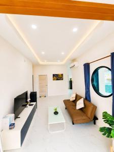 a living room with a couch and a table at X2 privacy villa in Khon Kaen