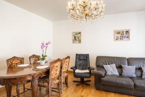 a living room with a table and a couch at Gîte l' Odyssée in Espalion +12 photos