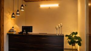 an office with a reception desk with lights at Gauri Hayat Corbett Retreat in Rāmnagar +21 photos