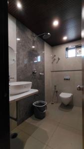 a bathroom with a sink and a toilet at 7 Pearls in Gajendragarh