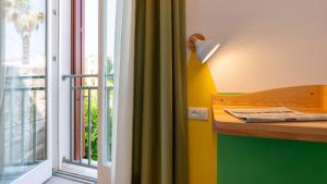 a desk with a lamp next to a window at Cava del Mare in Favignana +48 photos