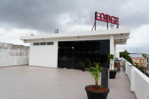 a white building with a sign on top of it at 7 Pearls in Gajendragarh