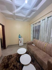 a living room with a couch and two tables at Arabella Homes in Maralal